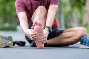 man rubbing foot